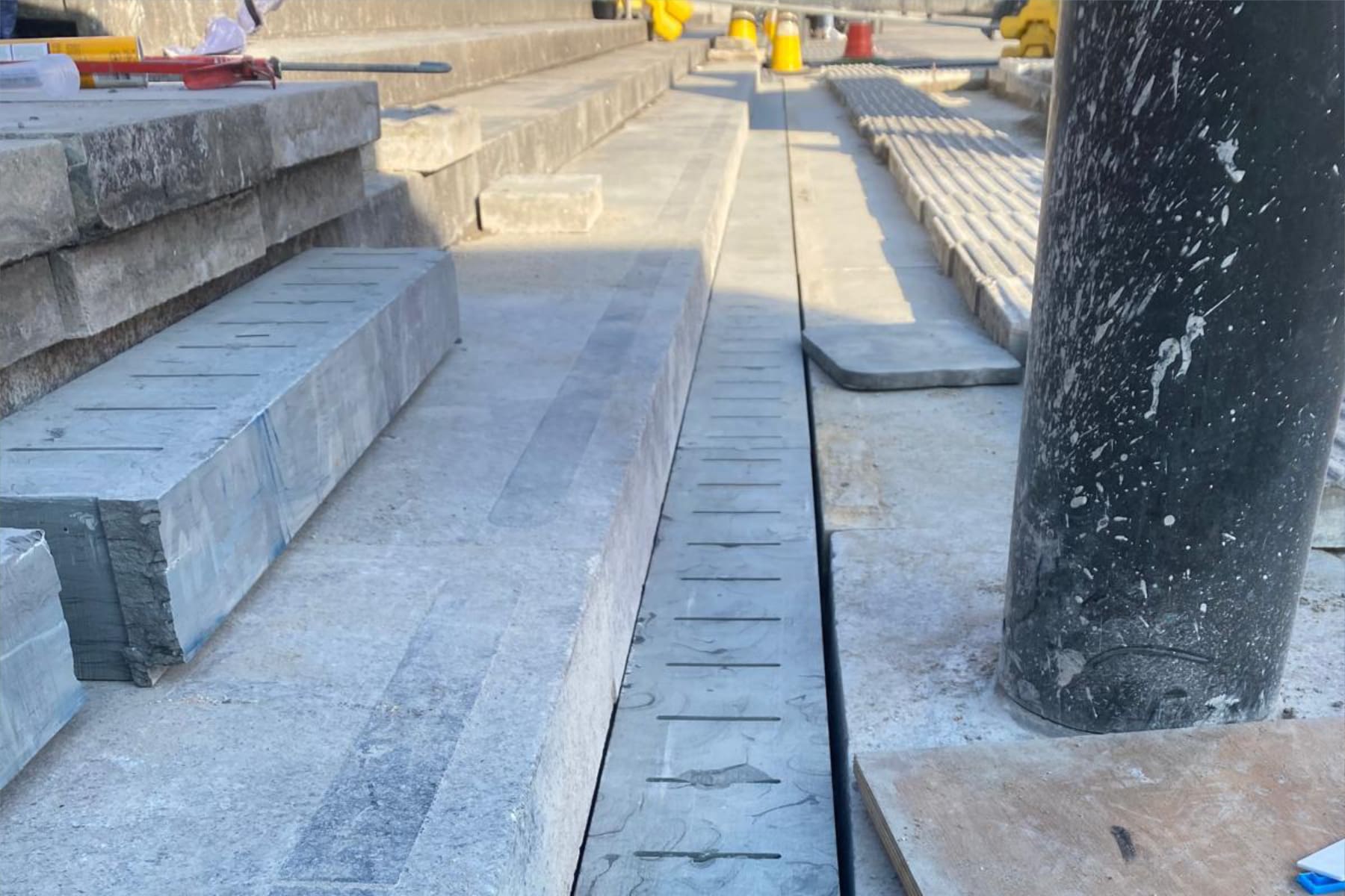 New Yorkstone drainage channel being installed alongside the granite steps at Trafalgar Square, London